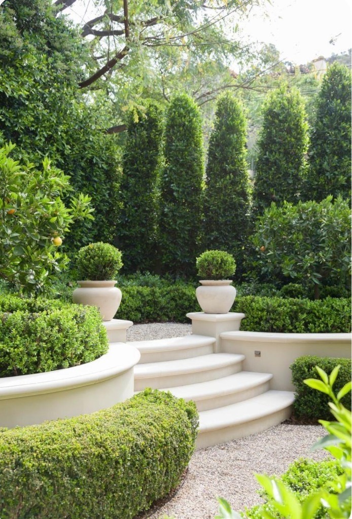 Private garden entrance with stone steps and topiary